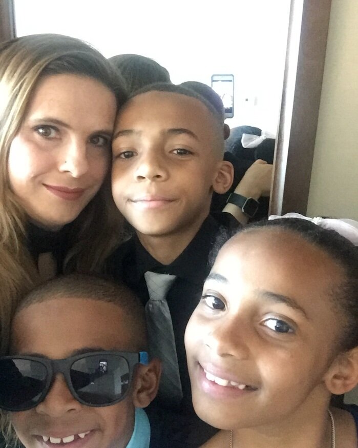 Jennifer and her three kids smiling