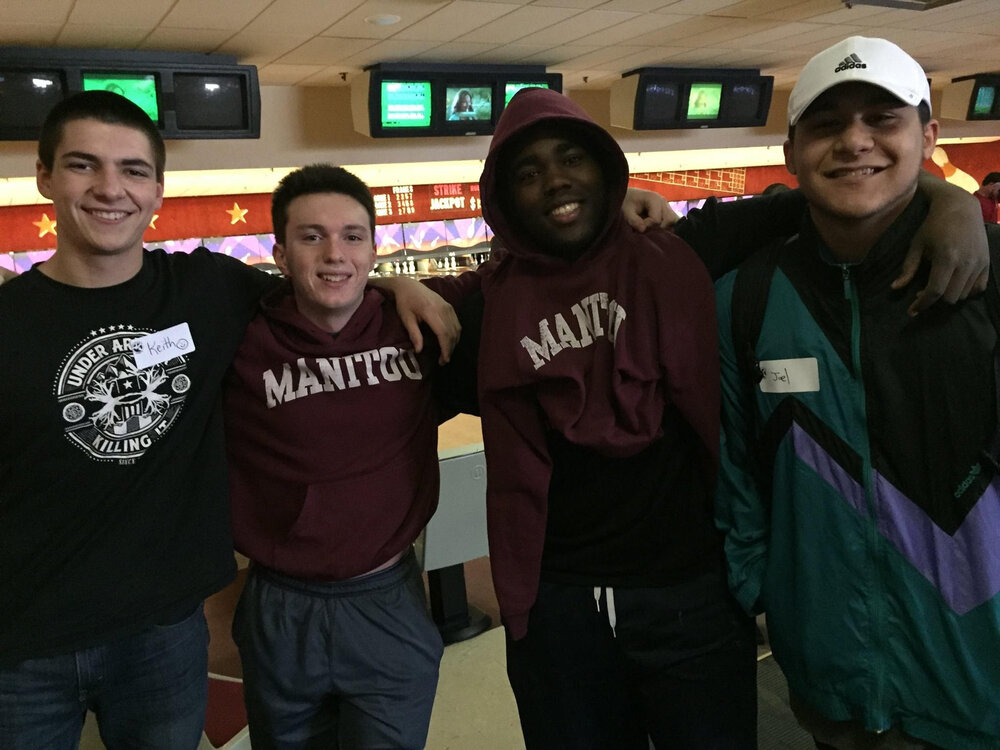 Four campers at a bowling alley