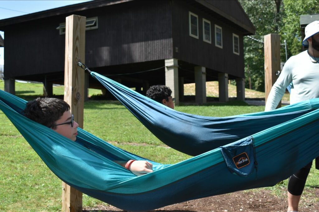 Boy sitting in hammock at grief camp