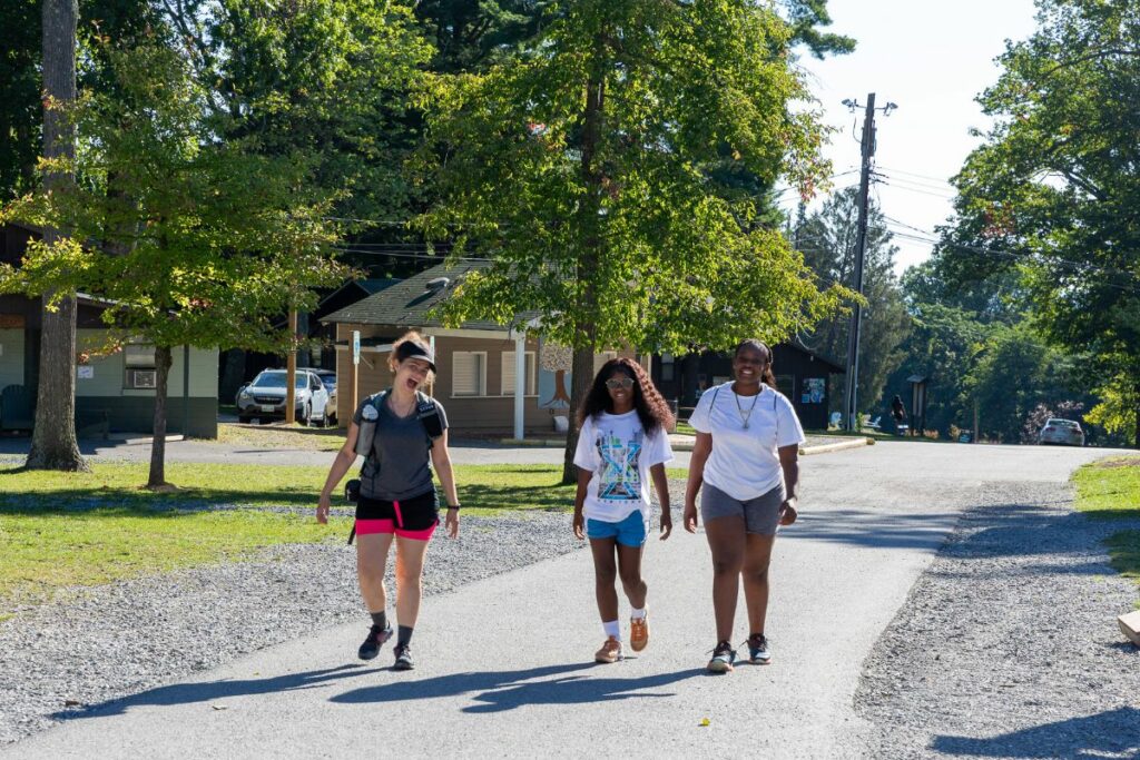 Three girls walking together at grief camp