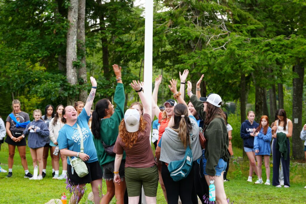 Girls at flag pole at camp